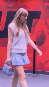 Taylor Swift pairs cable-knit vest with pleated miniskirt at Nebraska vs. Cincinnati game
